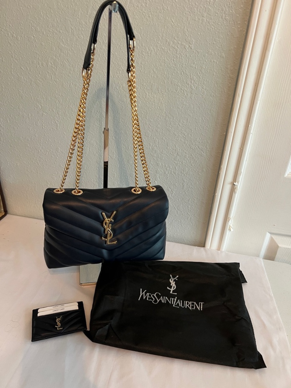 Yves Saint Laurent Navy Blue with gold tone chain and emblem. - Picture 2 of 11